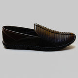 Black sandal on a light gray floor
