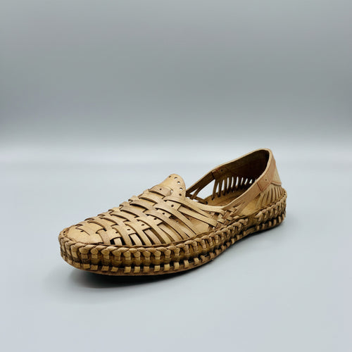 Woven sandal on a light-colored floor