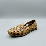 Woven sandal on a light-colored floor