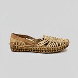 Woven sandal on a cracked concrete floor